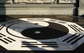 An impressively large octagon Yin, Yang, and Qi symbol inlaid into a temple wood plank floor.