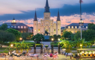 Panorama photo of the French Quarter in New Orleans, Louisiana, showing horse carriages lined up in front of Jackson Square